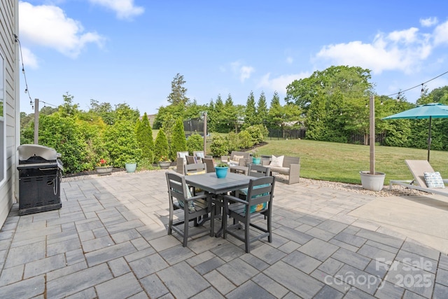 view of patio featuring a fenced backyard, outdoor dining area, and a grill