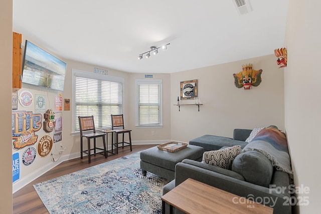 living area with baseboards, dark wood-style floors, and visible vents