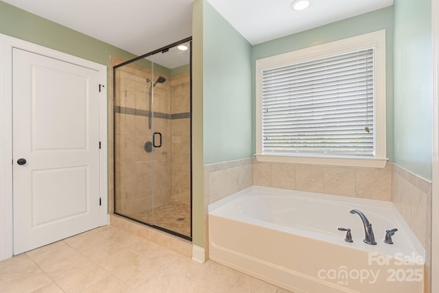 full bath featuring a garden tub, tile patterned flooring, and a shower stall