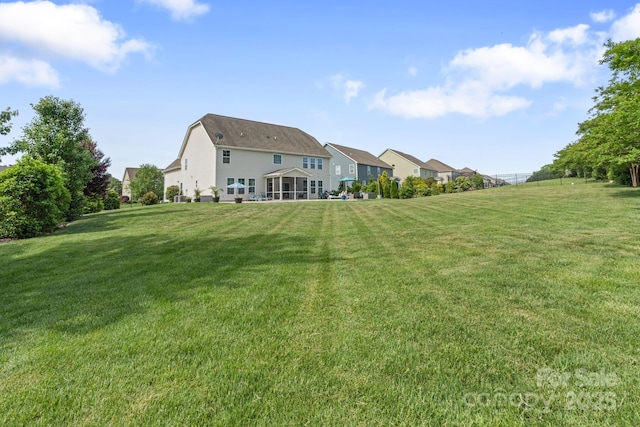 back of property featuring a lawn