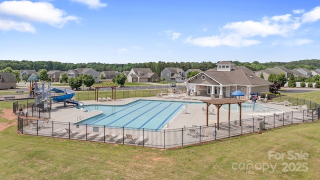 community pool with fence, a patio, a lawn, a water slide, and a residential view