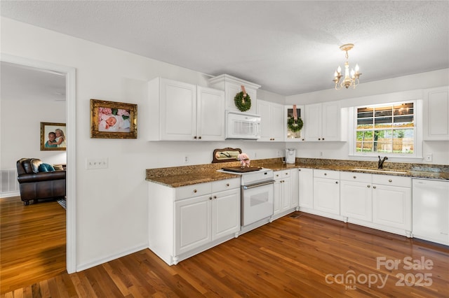 709 Weldon Ln, Salisbury, NC 28146 - kitchen with an inviting chandelier, dark stone counters, white appliances, and dark wood-style floors