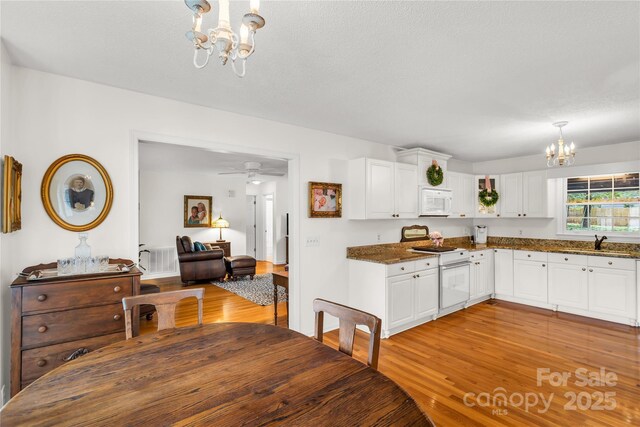 709 Weldon Ln, Salisbury, NC 28146 - dining space featuring light wood-type flooring and a notable chandelier
