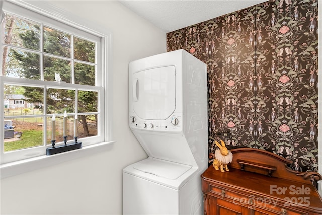 709 Weldon Ln, Salisbury, NC 28146 - laundry area with a textured ceiling, laundry area, wallpapered walls, and stacked washer / dryer