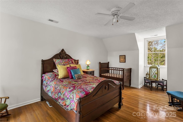 709 Weldon Ln, Salisbury, NC 28146 - bedroom featuring wood-type flooring, visible vents, baseboards, a textured ceiling, and a ceiling fan