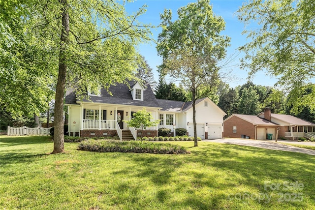 709 Weldon Ln, Salisbury, NC 28146 - new england style home with a front lawn, covered porch, a shingled roof, concrete driveway, and an attached garage
