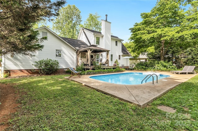 709 Weldon Ln, Salisbury, NC 28146 - rear view of property with a lawn, a chimney, a deck, and an outdoor pool