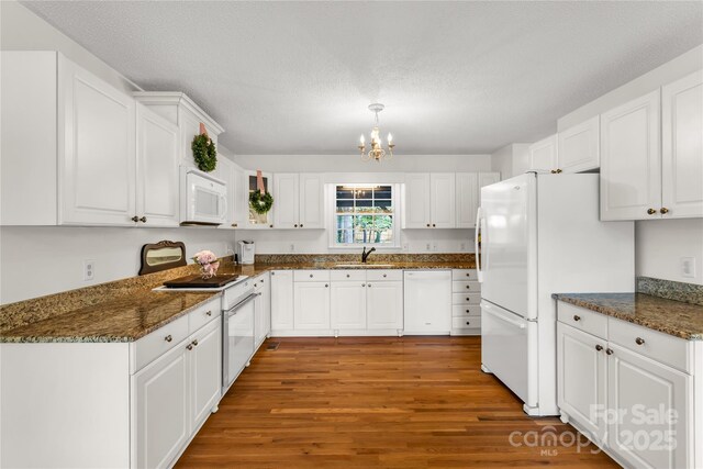 709 Weldon Ln, Salisbury, NC 28146 - kitchen featuring white cabinets, a notable chandelier, a sink, white appliances, and light wood-style flooring
