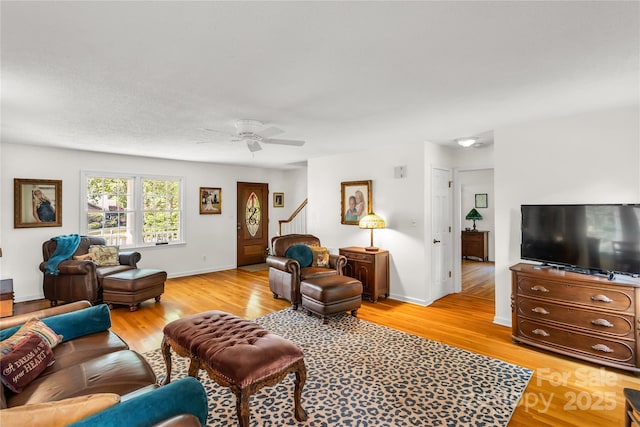 709 Weldon Ln, Salisbury, NC 28146 - living area with baseboards, a ceiling fan, light wood finished floors, and stairs