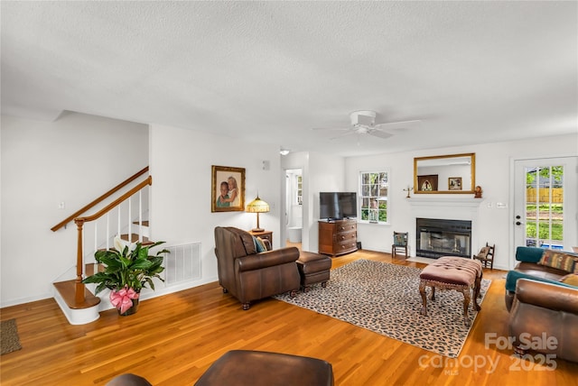 709 Weldon Ln, Salisbury, NC 28146 - living room with a fireplace with flush hearth, plenty of natural light, and wood finished floors