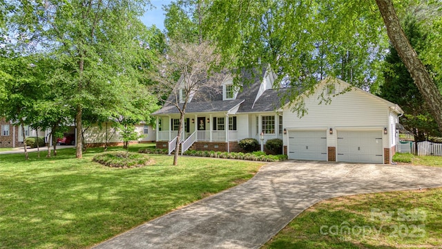 709 Weldon Ln, Salisbury, NC 28146 - cape cod home with a front lawn, brick siding, a garage, concrete driveway, and covered porch