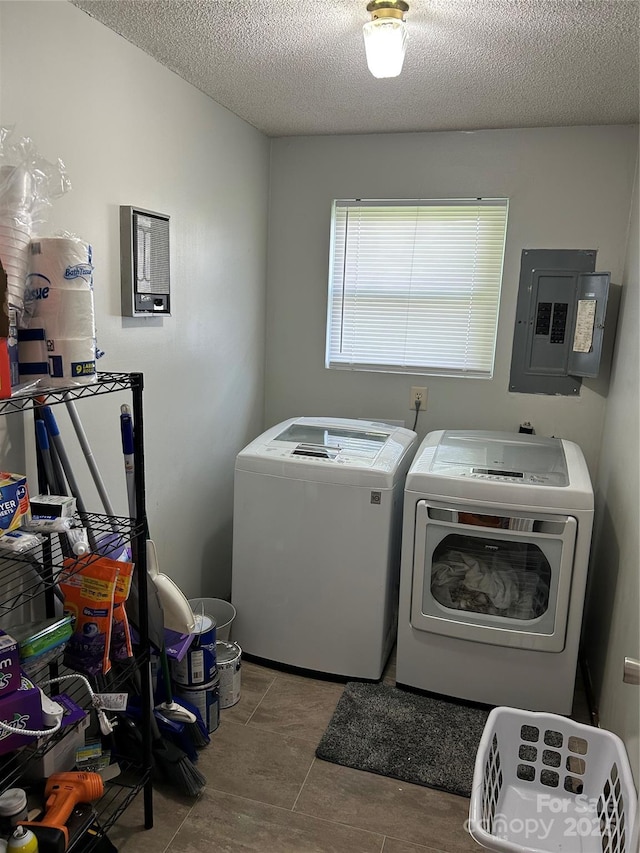 laundry area featuring a textured ceiling, electric panel, independent washer and dryer, and laundry area