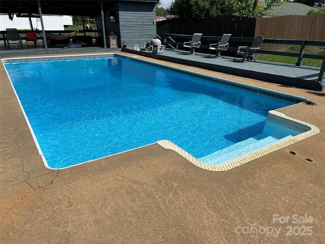 view of pool with fence, a fenced in pool, and a patio