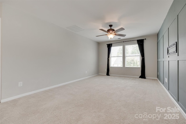 unfurnished bedroom with visible vents, a ceiling fan, baseboards, and light carpet