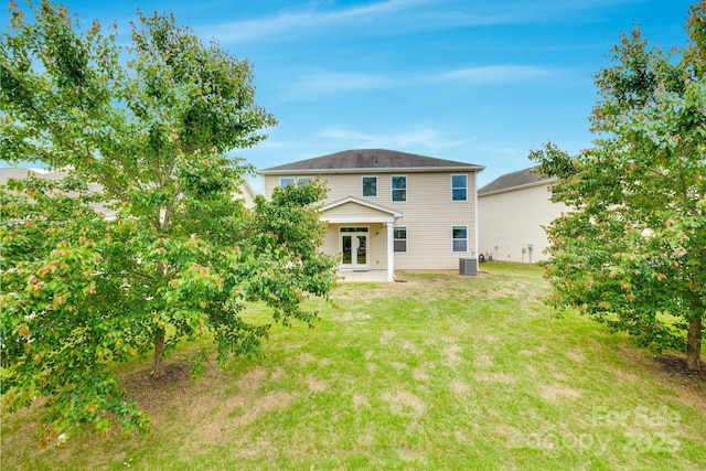 back of property featuring a lawn, a patio, central AC, and french doors