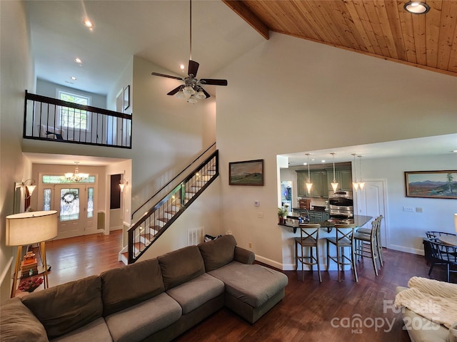 521 Hobson Rd, Bakersville, NC 28705 - living room with high vaulted ceiling, dark wood finished floors, a chandelier, stairs, and baseboards