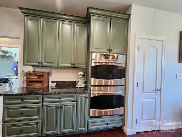 521 Hobson Rd, Bakersville, NC 28705 - kitchen featuring stainless steel double oven, green cabinets, dark wood-style floors, and dark stone counters