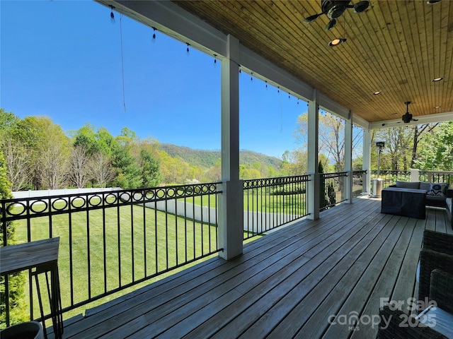 521 Hobson Rd, Bakersville, NC 28705 - deck with ceiling fan, a lawn, an outdoor living space, and a mountain view