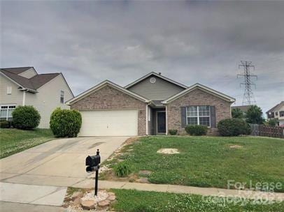 ranch-style home featuring a garage, concrete driveway, a front lawn, and brick siding