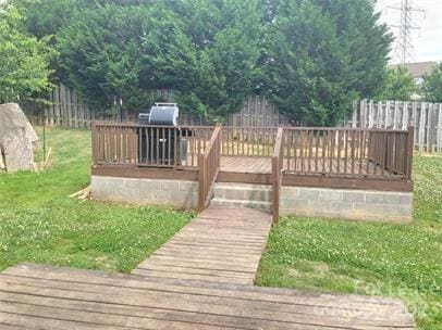 deck featuring fence and a lawn