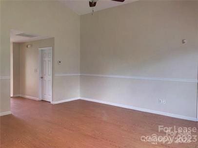 unfurnished room featuring baseboards, ceiling fan, and wood finished floors