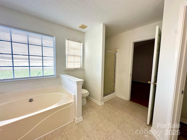 8551 Appledale Dr, Charlotte, NC 28262 - bathroom featuring toilet, a bath, a shower stall, a textured ceiling, and baseboards