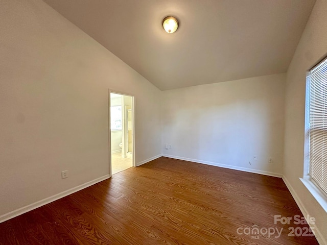 8551 Appledale Dr, Charlotte, NC 28262 - unfurnished room with vaulted ceiling, dark wood finished floors, and baseboards