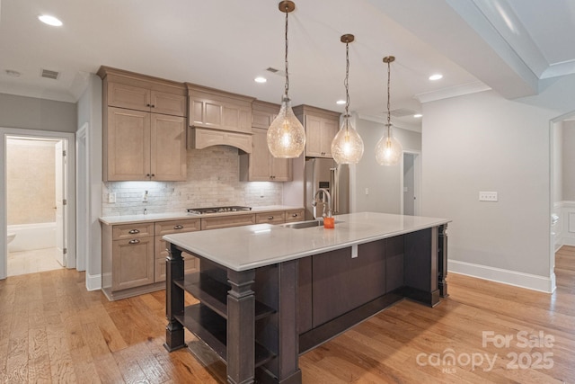 kitchen with appliances with stainless steel finishes, a sink, open shelves, light countertops, and light wood-style floors
