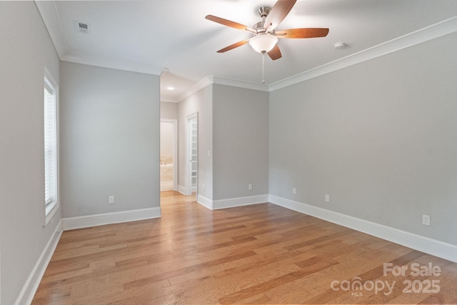 unfurnished room with a ceiling fan, crown molding, light wood-type flooring, baseboards, and a smoke detector