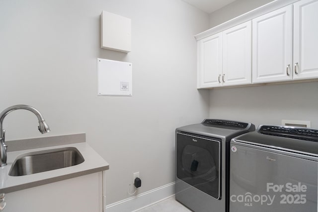 laundry area featuring cabinet space, washing machine and dryer, baseboards, and light tile patterned floors