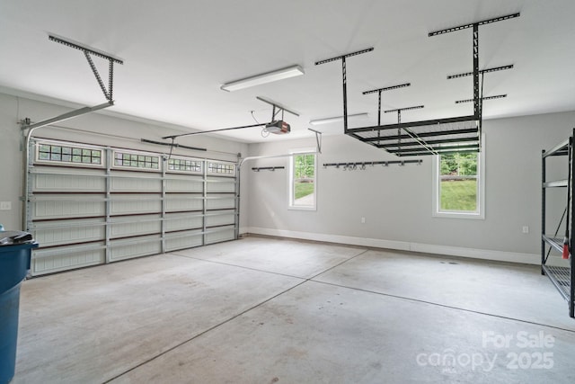 garage with a garage door opener and baseboards
