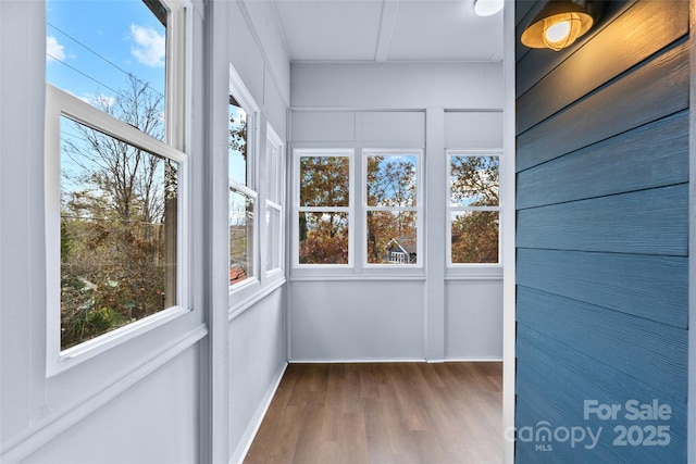 unfurnished sunroom featuring wood finished floors