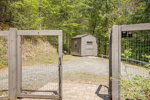16 Caddis Ct, Marshall, NC 28753 - gate featuring a shed, an outdoor structure, and fence