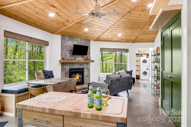 16 Caddis Ct, Marshall, NC 28753 - living area featuring stacked washer / dryer, wood ceiling, finished concrete flooring, healthy amount of natural light, and ceiling fan