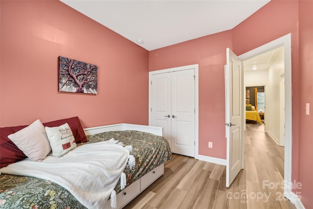 104 Trellis Ln, Troutman, NC 28166 - bedroom featuring light wood-style floors, baseboards, a closet, and attic access
