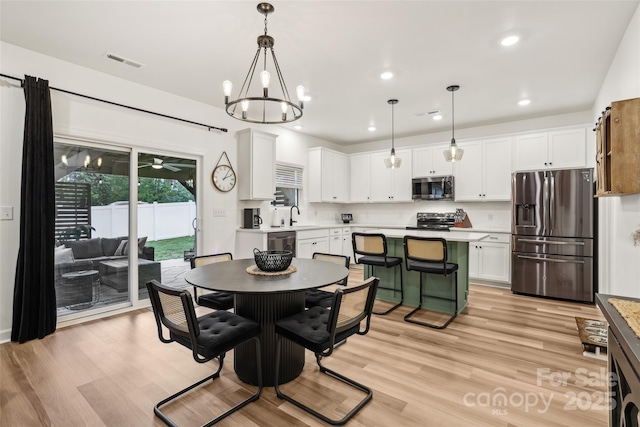 104 Trellis Ln, Troutman, NC 28166 - dining room featuring light wood-style flooring, ceiling fan, recessed lighting, and a chandelier