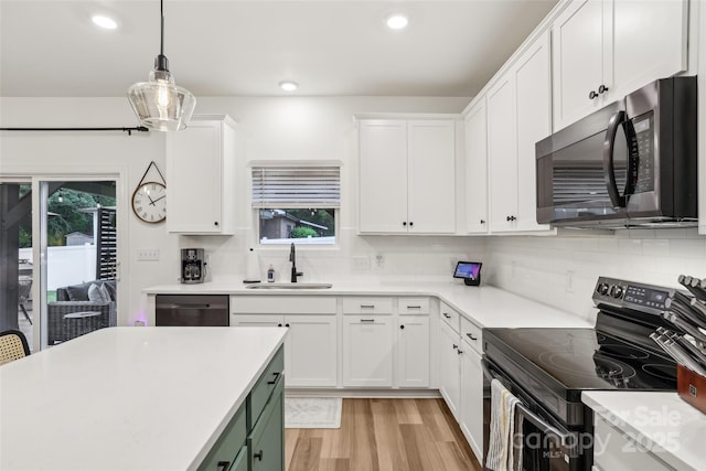 104 Trellis Ln, Troutman, NC 28166 - kitchen with black microwave, range with electric cooktop, a sink, dishwashing machine, and plenty of natural light