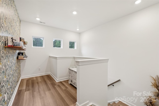 104 Trellis Ln, Troutman, NC 28166 - hallway with an upstairs landing, wood finished floors, recessed lighting, and baseboards