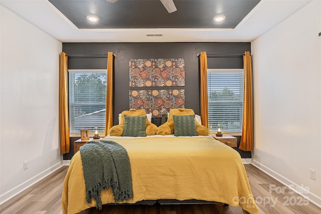 104 Trellis Ln, Troutman, NC 28166 - bedroom featuring a tray ceiling, wood finished floors, baseboards, and recessed lighting