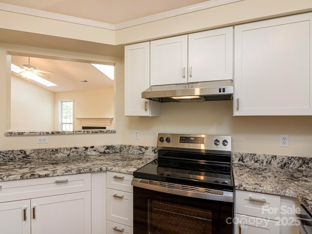 kitchen featuring white cabinets, under cabinet range hood, and electric range