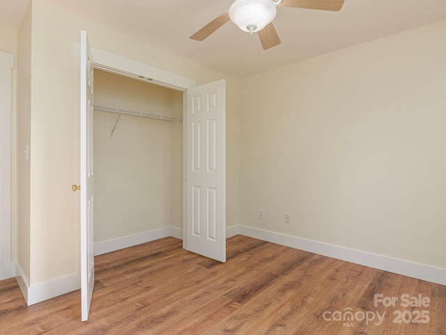 unfurnished bedroom featuring a closet, baseboards, and light wood-type flooring