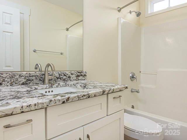 bathroom featuring toilet,  shower combination, and vanity
