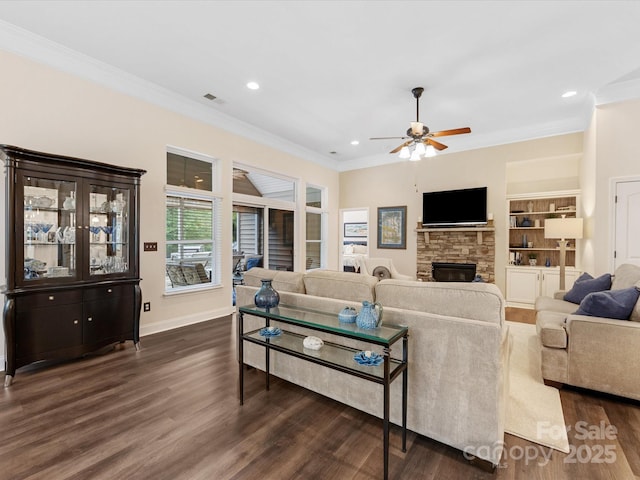 living room featuring visible vents, a fireplace, crown molding, dark wood-style flooring, and a ceiling fan