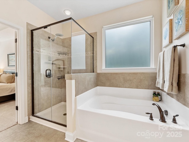 full bath featuring tile patterned floors, a garden tub, ensuite bath, and a shower stall