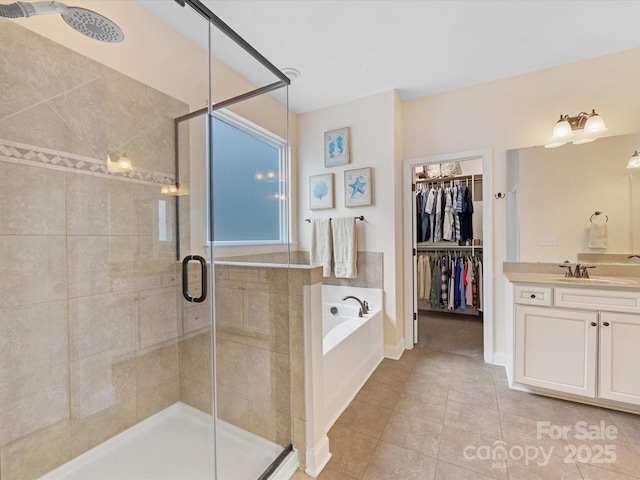 full bathroom featuring a stall shower, tile patterned floors, and a garden tub