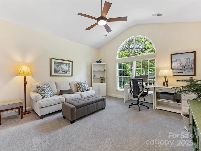 carpeted home office with a ceiling fan, baseboards, visible vents, and vaulted ceiling