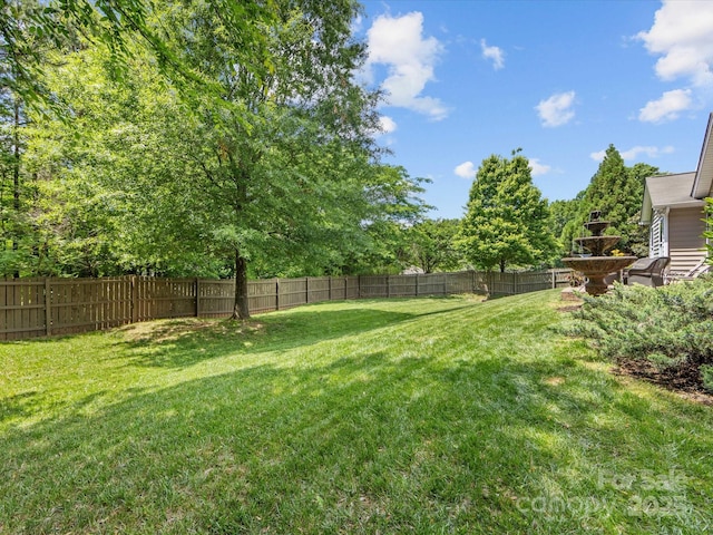 view of yard with a fenced backyard