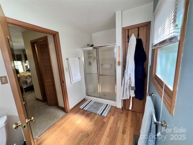 5A Hedgerose Ct, Asheville, NC 28805 - ensuite bathroom featuring wood finished floors, baseboards, ensuite bath, and a stall shower