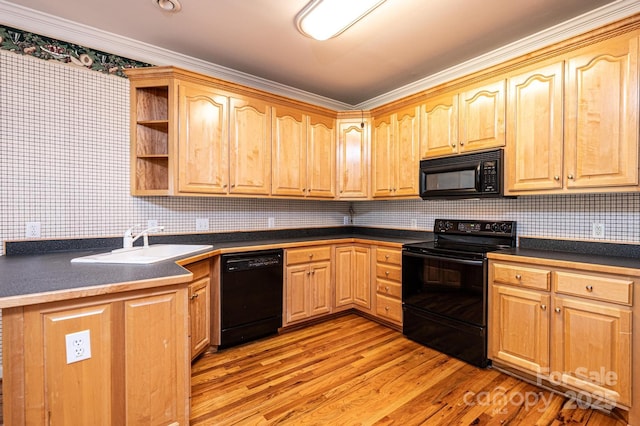 kitchen featuring open shelves, dark countertops, light wood-style floors, a sink, and black appliances