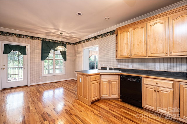 kitchen featuring a sink, ornamental molding, black dishwasher, and a peninsula